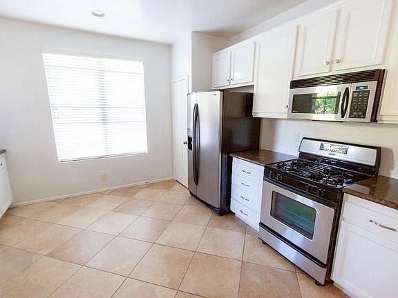 Kitchen with stainless appliances and recently painted cabinets