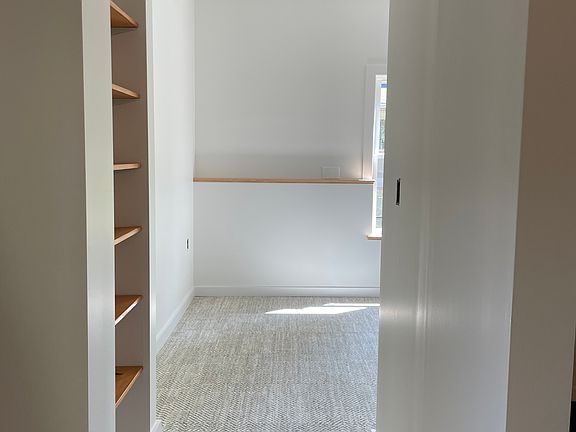 Living space off of Kitchen/Dining. Built-in shelving, south facing window and lots of daylight.
