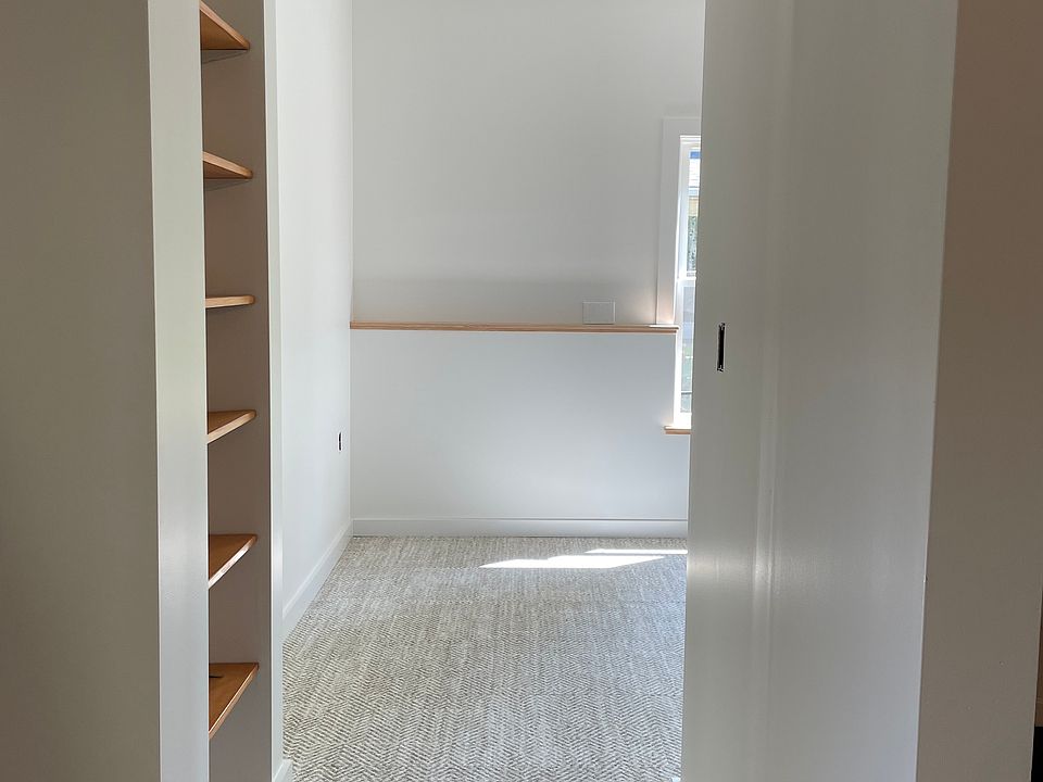 Living space off of Kitchen/Dining. Built-in shelving, south facing window and lots of daylight.