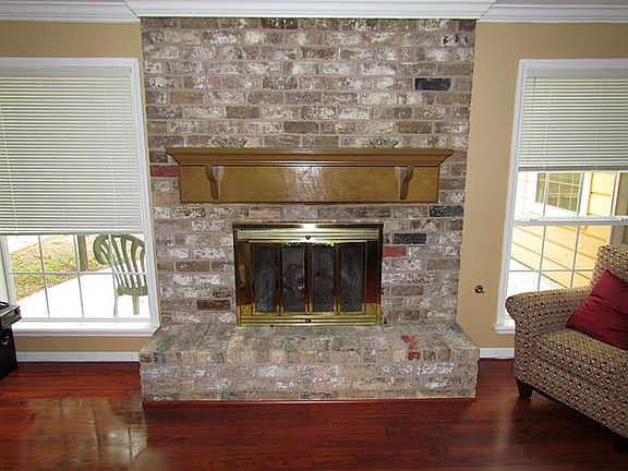 The fireplace is the focal point of the den.