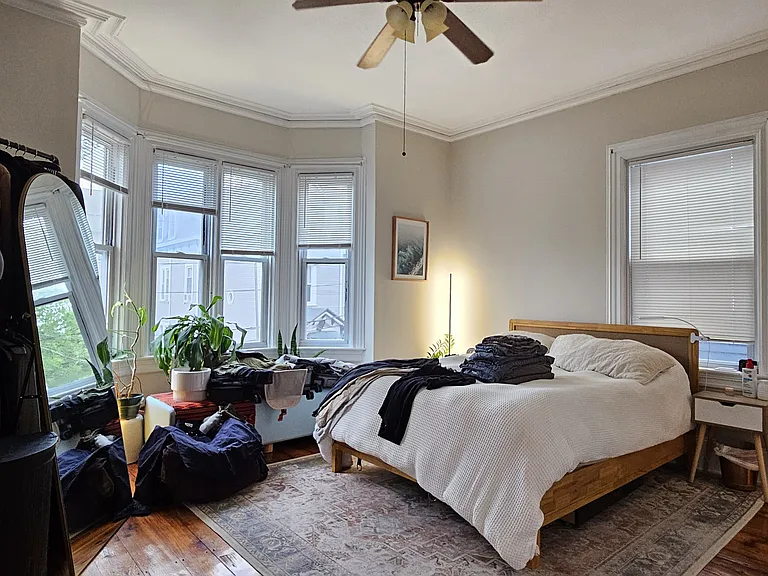 Master bedroom suite with bay windows, large closet, and en-suite bathroom
