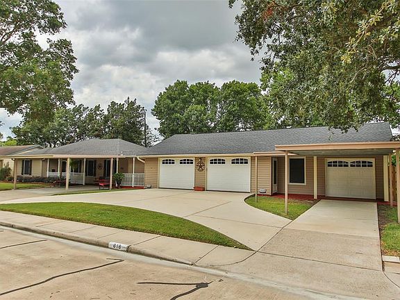 Another view of this oversized 3 car garaged with semi circle driveway