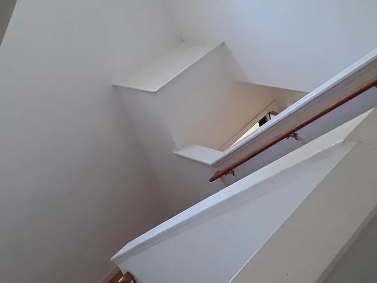 Open stairwell looking down from above. Plenty of natural daylight