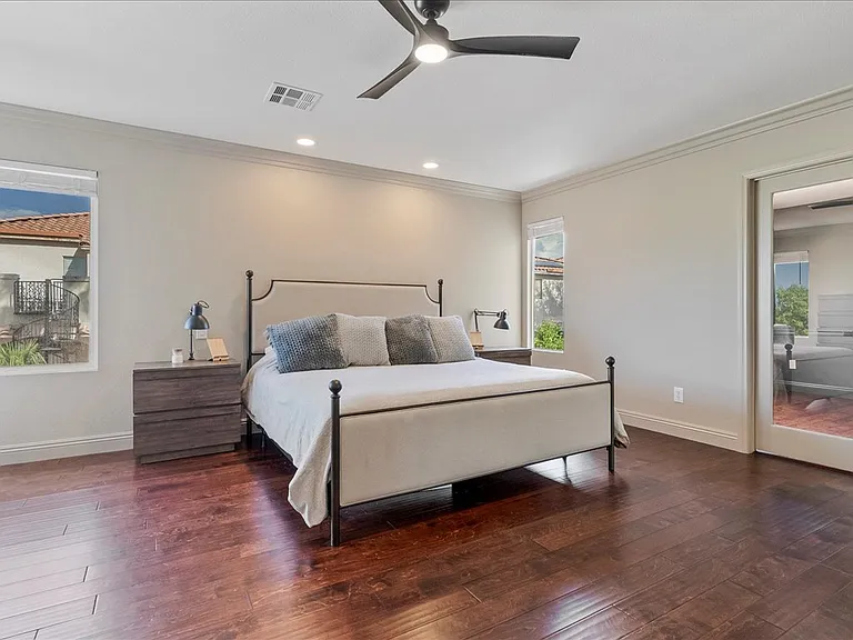 Zen like primary bedroom with luxury bed 22 inch king pillow top mattress, tv and fireplace