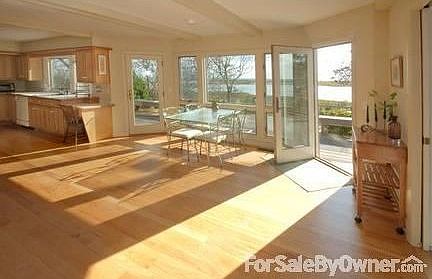 Bkfst area and kitchen with great views
						:
						Fireplace and large windowed room earns the name Tidewatch for this Cape beauty