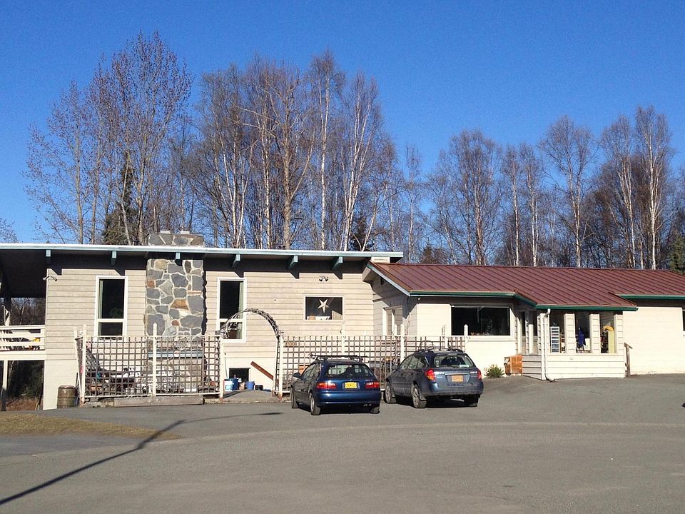 Triplex with garages down on left side of house and front door off patio