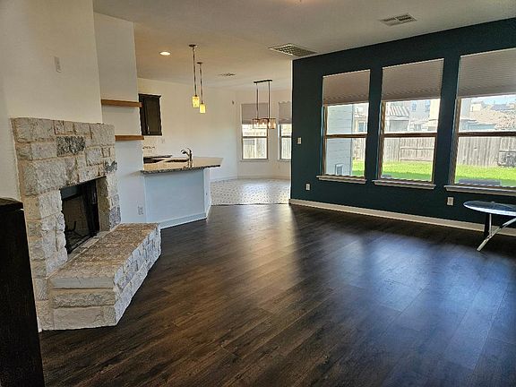 Living room w/ wood-burning fireplace
