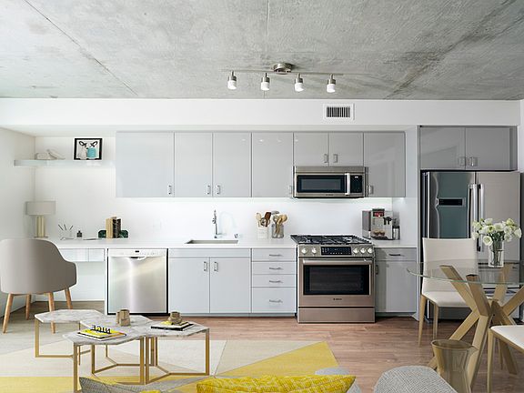 Chic apartments with custom cabinetry, galley kitchens and double door refrigerators