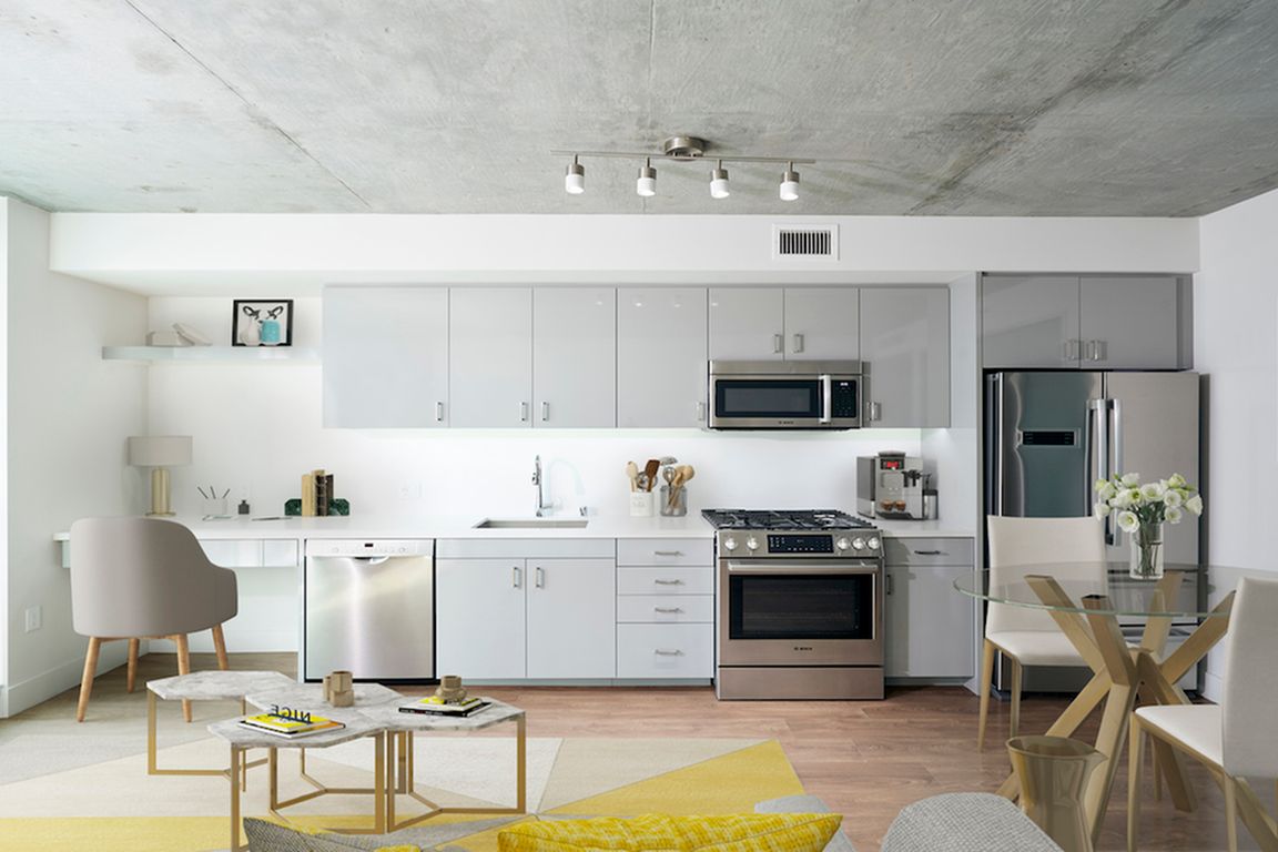 Chic apartments with custom cabinetry, galley kitchens and double door refrigerators