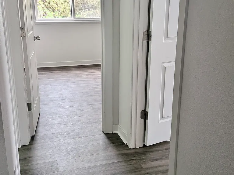 2nd floor hallway leads to bathroom, 2 bedrooms