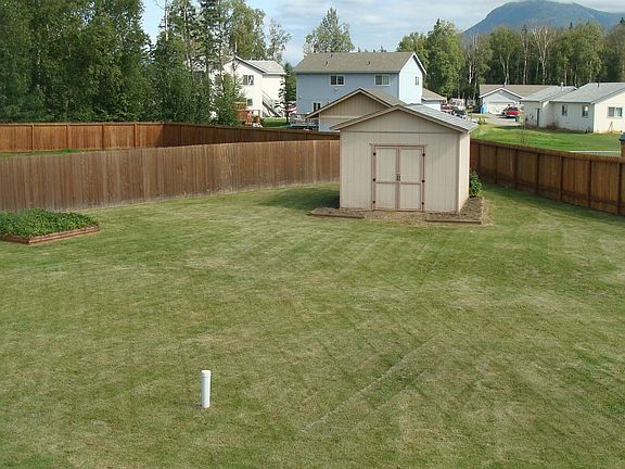 large back yard with shed.