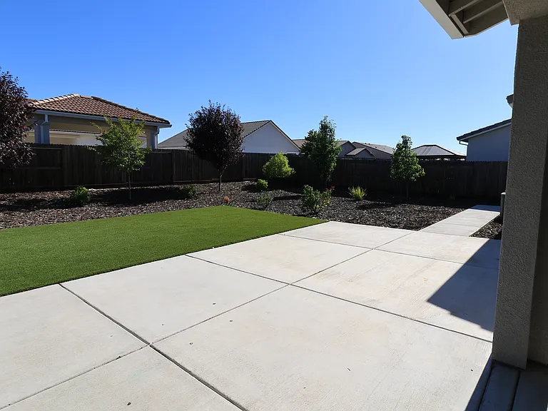 View from the patio door to the backyard. That's artificial turf, so NO mowing!