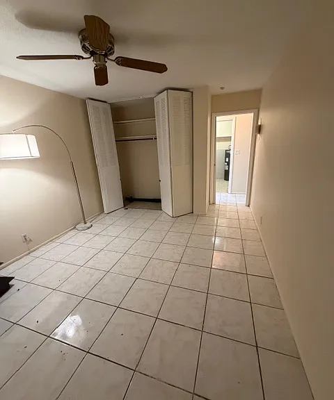Bedroom with Closet and Ceiling Fan. A Walk-in closet just outside door in Hall.