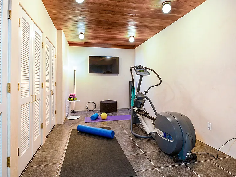 Exercise Room with Apple TV and Elliptical Trainer