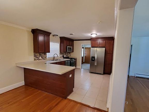 Dining Area into Kitchen and then into Utility Room w/ door to back yard and door into garage.