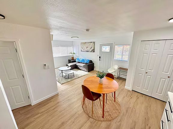 Comfortable living room with a Smart TV, cozy seating, and air conditioning.