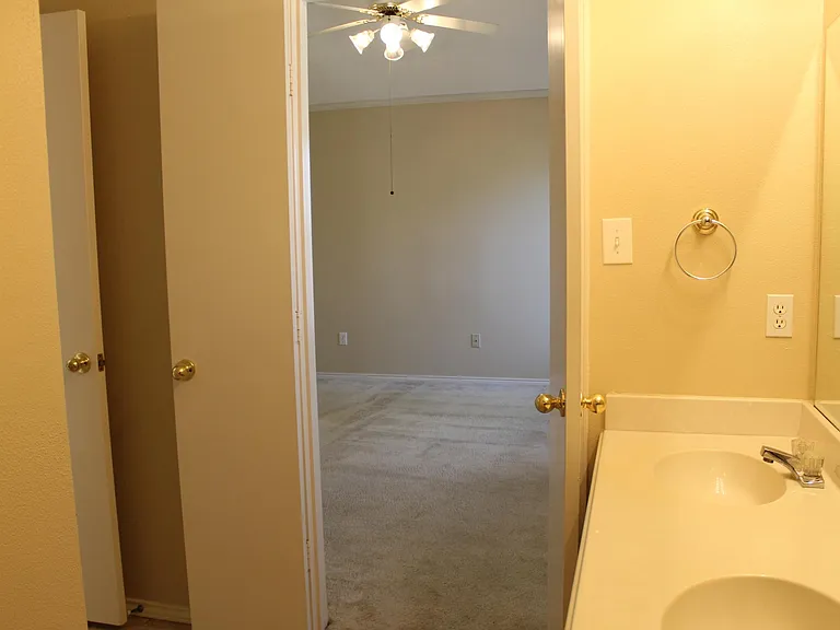 View into primary bedroom from primary bath