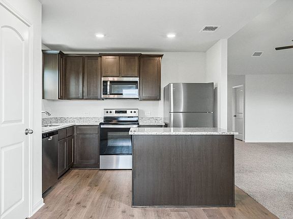The kitchen of the Sabine has gorgeous wood cabinetry.