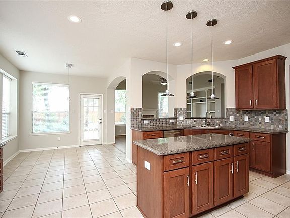 Another view of this island kitchen looking into the breakfast room.   Both rooms, as well as most of the other rooms, have updated lighting fixtures, besides flooring, extended patio, Nest thermostats, fence with 4 year warranty, light switches, ceiling fans, sprinkler system, water heater, and it just keeps going.  This home has SO much to offer and it IS move in ready!
