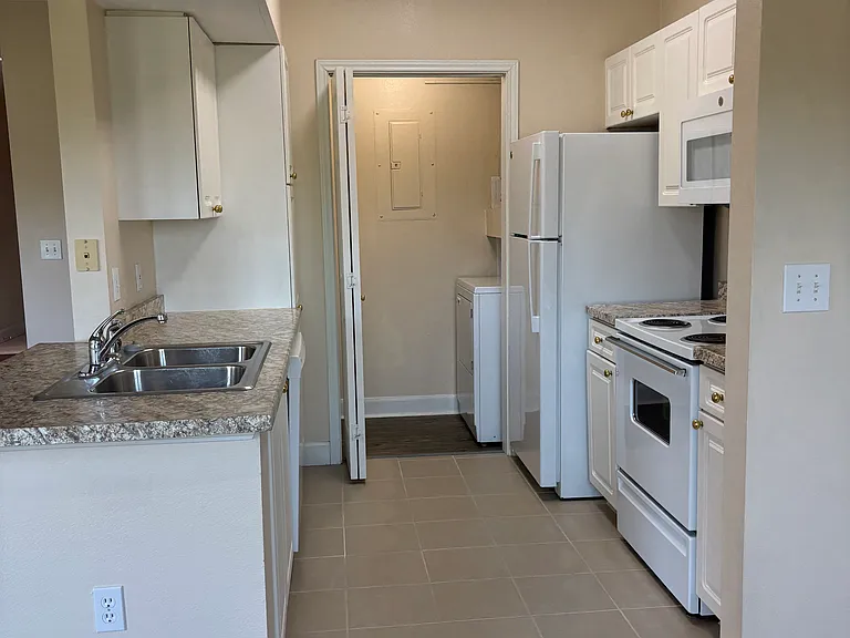 Kitchen, laundry door open at the back.