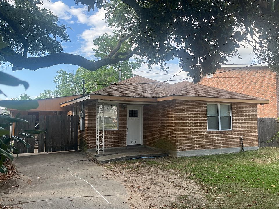FRONT OF HOUSE ON W. METAIRIE AVE, DRIVEWAY to covered car port.
