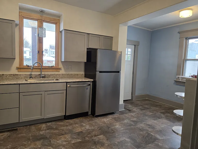 View from the doorway into the kitchen right side with laundry and back door on the right.