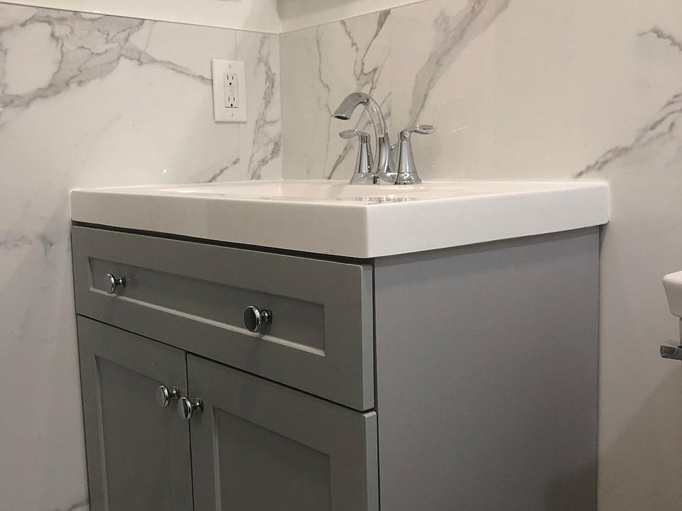 Bathroom is custom built. Walk in shower, wall mounted bathroom vanity mirror with LED light, dimmer and defroster, all ultra-modern fixtures. Trendy gray and white Carrera look with easy to clean porcelain tiles.