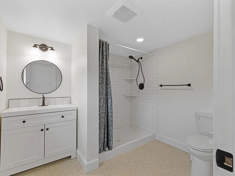 3/4 bath at the top of the stairs w/ custom tile.