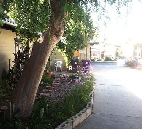 at end of driveway along side of lovely garden