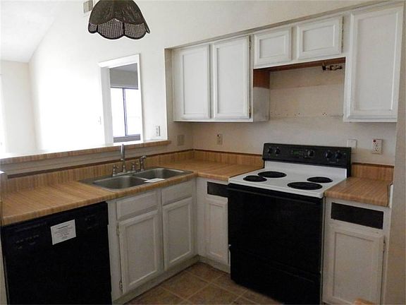 Kitchen has both dishwasher and free-standing electric stove and oven.
