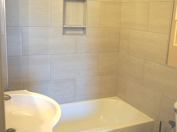 Brand new remodeled bathroom with tiled shower and new vanity.