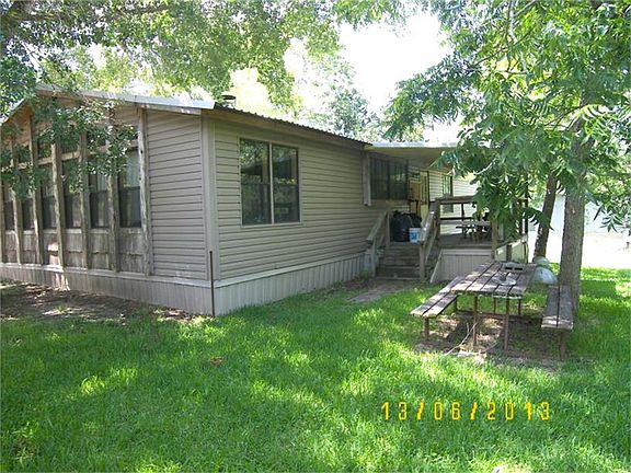 View of the back and side of the home. Needs some TLC. Painting.