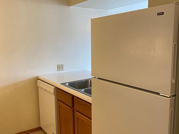 Galley Style Kitchen with Dishwasher and Refrigerator