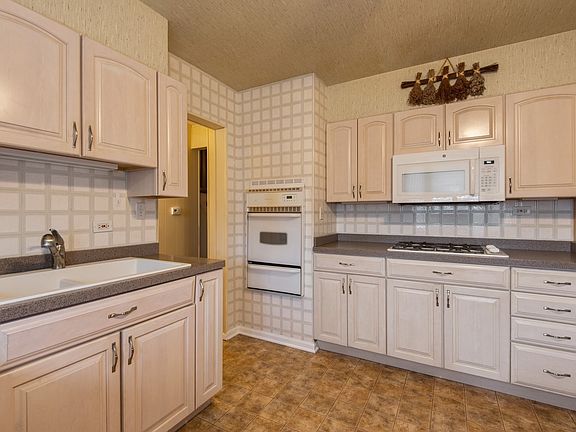 Lovely updated kitchen with corian counters and newer cabinets
