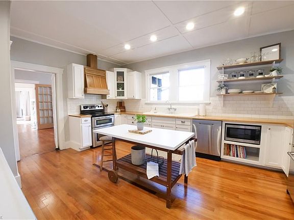 White custom cabinetry, subway tile backsplash and stainless appliances.