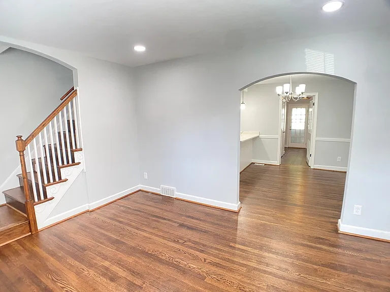 Main level - Living Room, Dining Area (with kitchen to the left), bedroom 3/den/work from home (WFH) office, plus stairs going up. All new paint throughout, all hardwood floors refinished.