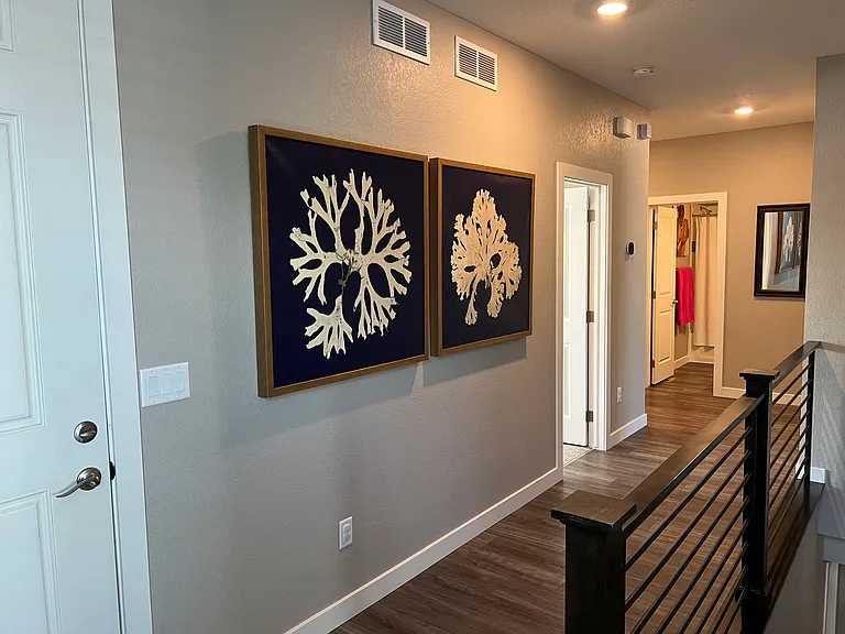 Hallway to bedroom, garage, laundry room and basement