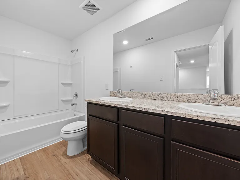 Full bathroom with a double-sink vanity.