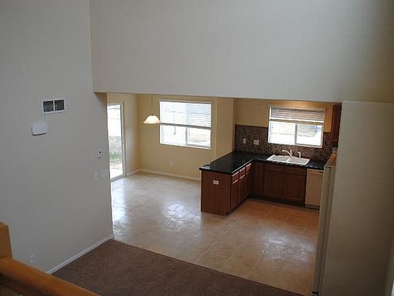 looking down into kitchen/dining from stairway