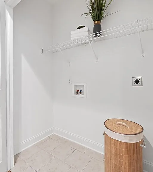 Laundry closet with upper shelf on lower level.