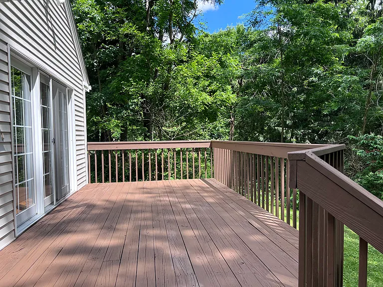 Very large private backyard and deck. View is of woods.