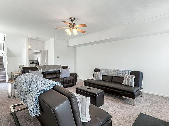 Living room right off of the kitchen/dining area. Stairs leading to bedrooms.