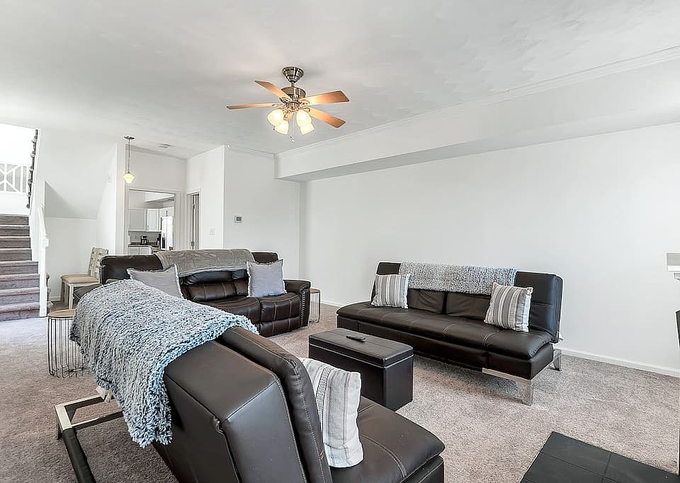 Living room right off of the kitchen/dining area. Stairs leading to bedrooms.