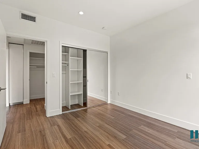Bedroom with Closet with Shelving, Recessed Lighting, and Vinyl Flooring