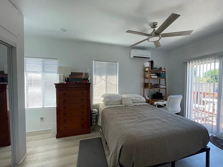 Main bedroom with sliding glass doors to the patio overlooking the back yard