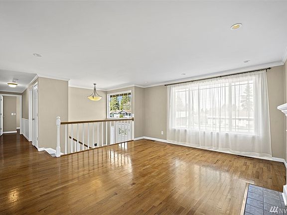 Hardwood floors leading down hallway to 3 bedrooms and full bath. 