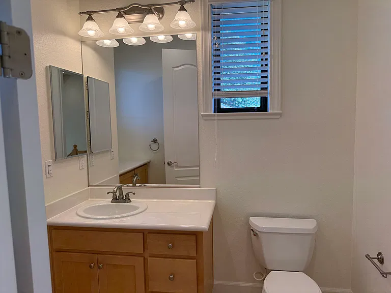 Third floor hallway bathroom features a shower stall and a storage cabinet.