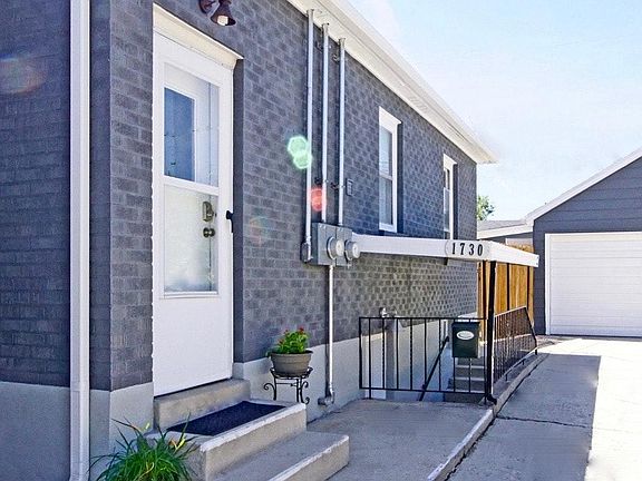 Separate entrance for basement unit (1730) is along driveway.