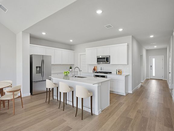 Kitchen in the Masters home plan by Trophy Signature Homes - REPRESENTATIVE PHOTO