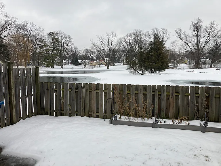 fenced in back yard overlooking pond